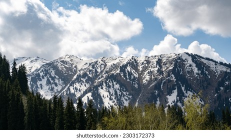 clouds over snowy mountain peaks. cloudy weather in the mountains - Powered by Shutterstock