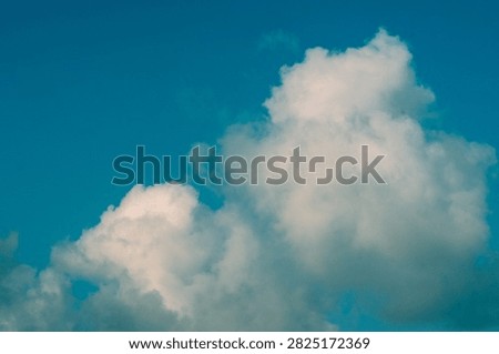 Clouds overus and clear blue sky