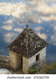 Clouds Reflected In The Dordogne River From The Chateau De La Treyne On The Banks Of The River In Late Autumn.