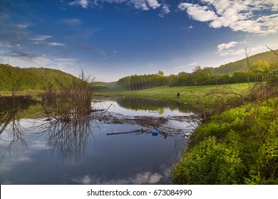 Clouds Reflected In Stagnant Water.