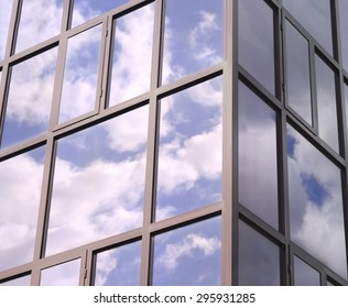 Clouds Reflected In The Tinted Windows Of The Building.