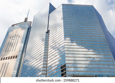 Clouds reflected in windows of modern office building
