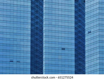 Clouds reflected in windows of modern office building.