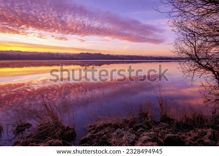 Clouds relect on Castle Semple Loch, Renfrewshire, Scotland.