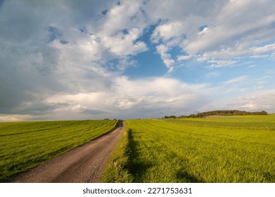 clouds and road ingreen field