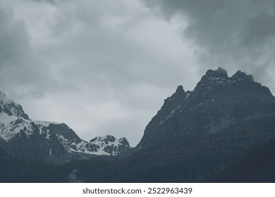 Clouds and rocky cliffs in Italy, Dolomiti. View in alps mountains. Snowy mountains in low clouds in rainy weather. - Powered by Shutterstock