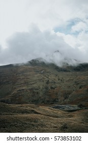 Clouds rolling over a mountain peak