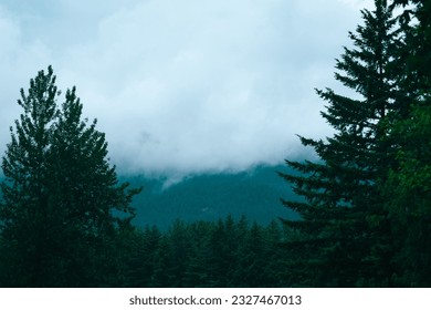 clouds rolling over a mountain side