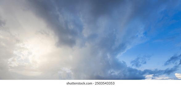 Clouds shift dramatically from dark gray to bright blue, revealing sunlight over a tranquil expanse, showcasing nature's beauty in transition.
