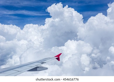 Clouds in the sky and city scape though airplane window. flying.