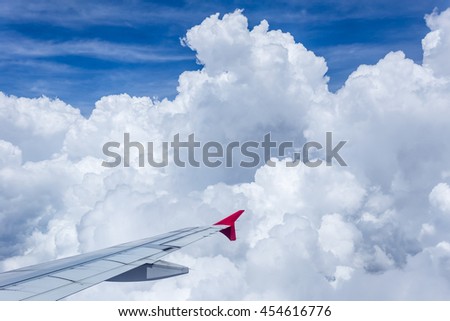 Clouds in the sky and city scape though airplane window. flying.