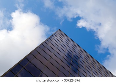 clouds and sky are reflected in the mirrored window constructed in high-tech style building - Powered by Shutterstock