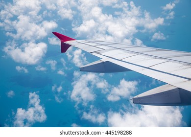 Clouds and sky as seen through window of an aircraft