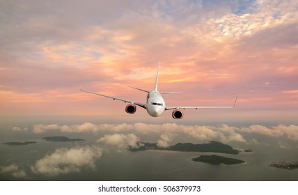 Clouds and sky as seen through window of an aircraft. Looking through window aircraft during flight in wing with a nice blue/purple/orange sky.