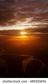 Clouds And Sky As Seen Through Window Of An Aircraft. Flying Over The Evening Timelapse Clouds With The Late Sun. Flight Through Moving Cloudscape With Beautiful Sun Rays.