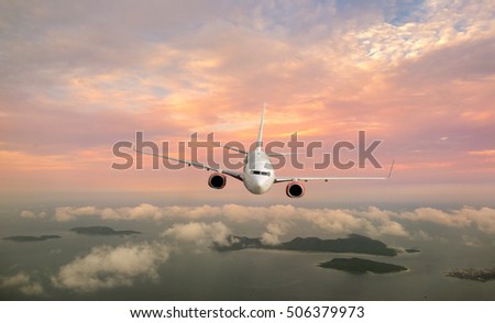 Clouds and sky as seen through window of an aircraft. Looking through window aircraft during flight in wing with a nice blue/purple/orange sky.