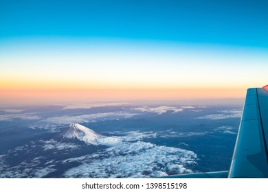 clouds sky skyscape and fuji mountain. Sunrise view from the window of an airplane flying in the clouds, top view clouds like the sea of clouds sky background, Aerial view background, Yamanashi, Japan - Powered by Shutterstock