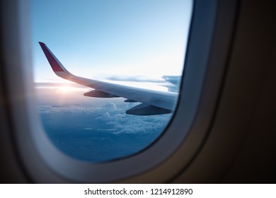 Clouds and sky with sunset as seen through window of an aircraft. Travel Concept