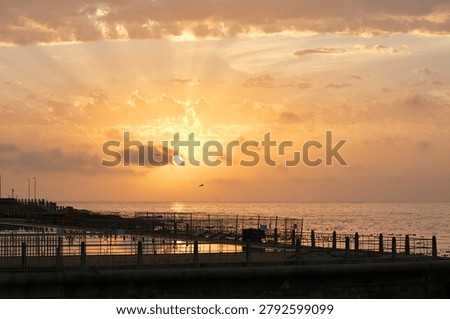 Clouds, space and sunset with pier at ocean for natural background or scenic wallpaper. Evening, horizon and sky with seaside boardwalk or jetty outdoor in nature for dusk and twilight scenery