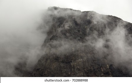 Clouds surrounding the top of a mountain