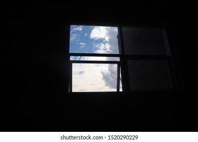 CLOUDS THROUGH WINDOW IN DIM ROOM
