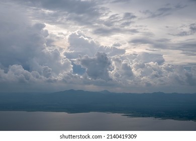 Cloudscape Above Moutain Range And Lake Water