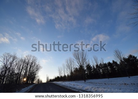 Cloudscape at dawn with blue sky and whispy clouds. 