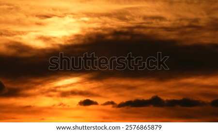 Cloudscape at extremely hot evening. Summer heat alert. Dark red sunset sky with bleeding red clouds. Dramatic view of a new scorch day in North America and heat wave.