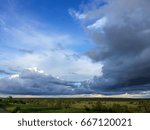 Cloudscape over river valley at sunset 
