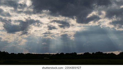 cloudscape sky with sunbeams through clouds