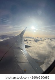 Cloudscape sunrise from plane window 