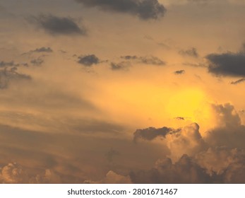 Cloudscape at sunset, with a relatively bright, roundish cloud that resembles the sun, early in summer in southwest Florida