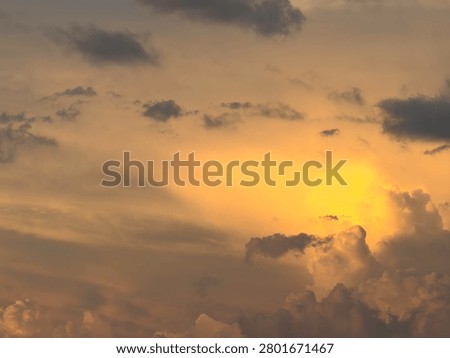 Cloudscape at sunset, with a relatively bright, roundish cloud that resembles the sun, early in summer in southwest Florida