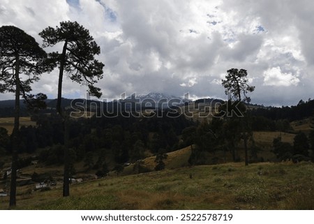 cloudscape at sunset with view of the Nevado de Toluca volcano with snow