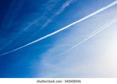 Cloudscape With Trail Of Jet Plane On Blue Sky. Natural Background.