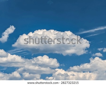 Cloudscape white clouds panorama. A wide panoramic of low-flying cumulus cloud of varying sizes. Voluminous space-occupying lesions of steam against a blue background. The sky in serene motion.