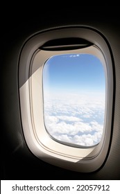 cloudscape of window at flying airplane