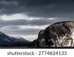 Cloudy bay with cliffs and distant mountains - Norris Point, Newfoundland, Canada.