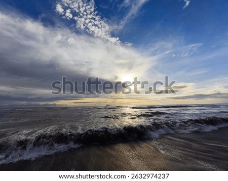 Cloudy beach sunrise with dramatic sky and incoming waves. Perfect for travel, nature, and relaxation themes. #sunrise #beach #ocean #clouds #nature #travel
