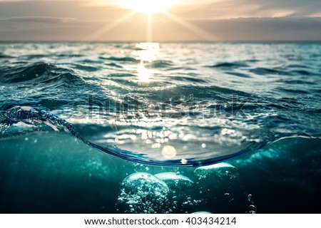 Cloudy Beautiful sunset in sea water. Design template separated by waterline.