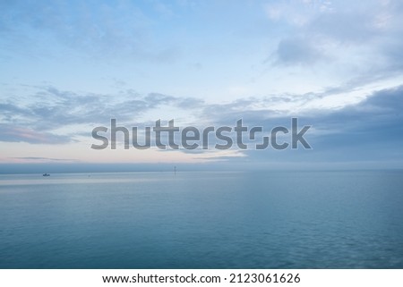 Cloudy blue minimalist seascape. Deserted space with horizon line. Imagine de stoc © 