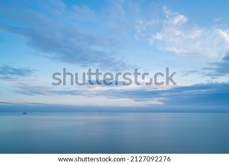 Cloudy blue minimalist seascape. Deserted space with horizon line.
 Imagine de stoc © 