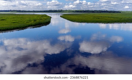 Cloudy blue sky reflected in the water of a wetlands landscape at the Two Rivers National Wildlife Refuge near Brussels, IL