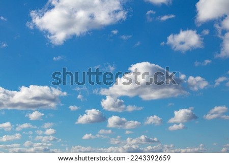 Cloudy blue sky, white clouds background with deep blue sky. Wallpaper with sunlight. Texture, pattern idea concept. Horizontal photo. No people, nobody.