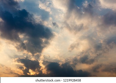 Cloudy Bright Yellow Sunset With Dark Clouds And Blue Sky