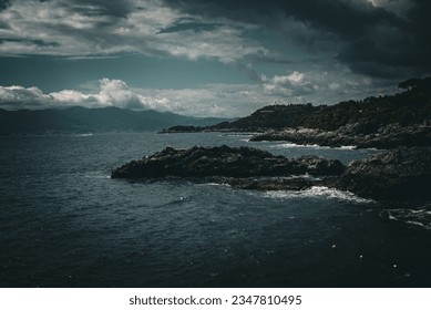 Cloudy day and stormy sea over the rocky coast
