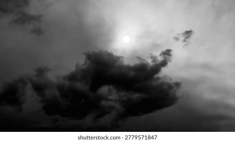 Cloudy and dramatic sky with a high contrast between dark clouds and sunlight.
The photograph is in black and white, which highlights the drama of the storm clouds. Dark mountains are silhouetted against the cloud-laden sky, suggesting a somber landscape. This type of cloud pattern often indicates the approach of rain or unstable weather conditions.