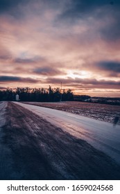 Cloudy Golden Purple Sunset Over Field Road With Silo