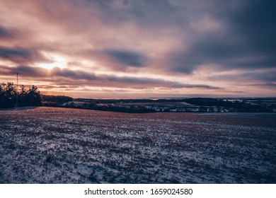 Cloudy Golden Purple Sunset Over Field