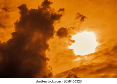 Cloudy landscape with a forming thundercloud at dusk at dawn. Shooting against a light source. Selective focus.